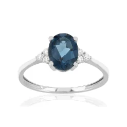 Bague or 375 blanc topaze bleue traitée et zirconias