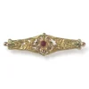 Broche d'occasion or 750 jaune doublet grenat verre